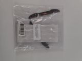 a knife in a plastic bag on a white surface