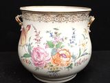 a vase with flowers painted on it on a black surface