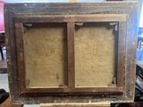 an old wooden frame with a painting on it sitting on a table