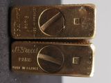 two gold bars sitting on top of each other on top of a table
