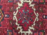 an oriental rug with a medallion design on a red background