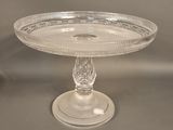 a glass cake plate on a pedestal on a table
