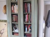 a tall bookcase with a bunch of books in it
