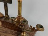 a candle holder that has a cross on top of it