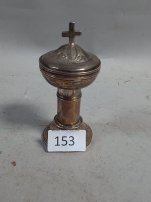 une image représentant un petit objet métallique surmonté d'une croix