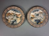 two plates with a painting of a man and a woman on them