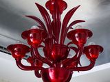 a red chandelier hanging from the ceiling in a room