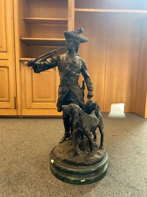 statue of a man with a dog and a gun in a room