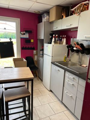 a small kitchen with a table and chairs in it