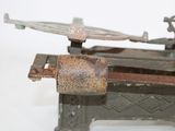 an old machine that is sitting on a white surface