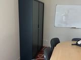 an image of a conference room with a whiteboard on the wall