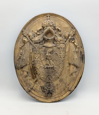 a close up of a gold plate with a coat of arms on it
