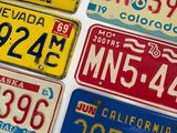 five different license plates on a white surface
