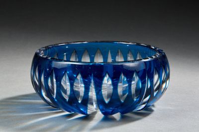 a blue glass bowl that is sitting on a table
