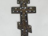 an old metal cross with a jesus on it