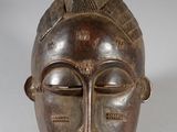 an image of a wooden mask on a white background