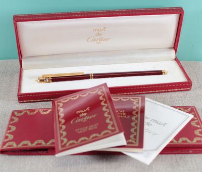 a red box with a pen in it on a table