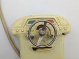 a small yellow machine with a steering on it
