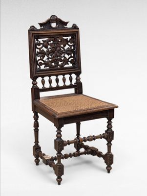 an old wooden chair with wicker seat on a white background