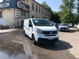 a white van that is parked in front of a building