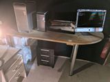 a desk with a computer on it in a room