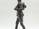 bronze statue of a soldier with a rifle on a white background