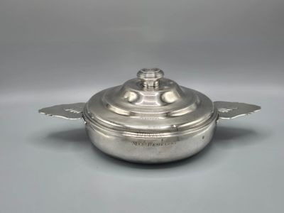 an antique silverplated casserole dish with a lid