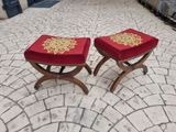 two stools that are sitting on a brick floor