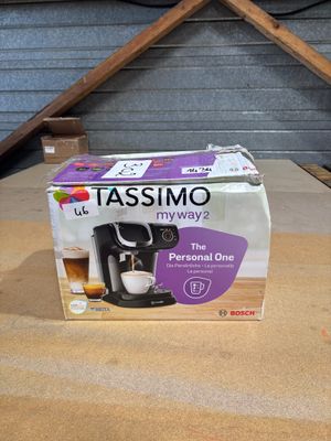 a box of tassino coffee maker on the table