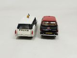 two toy cars that are next to each other on a white surface