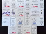 some of the cards have autographs on them on a black surface