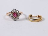 two gold rings with diamonds and a pink stone