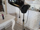 a hair dryer sitting on a stand in a room