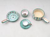 four pieces of tea and coffee set on a white surface