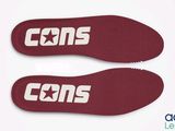 a pair of red shoes with the word cons on them
