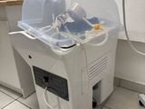 a machine that is sitting on the floor next to a sink