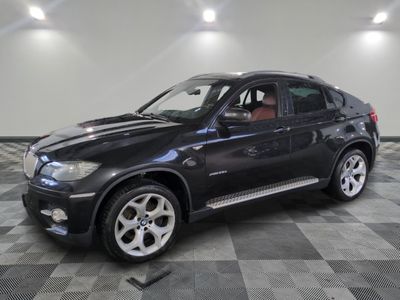 a picture of a black bmw suv on a checkered floor