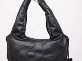 a close up of a black purse with a metal handle