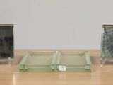 three glass blocks sitting on a wooden table
