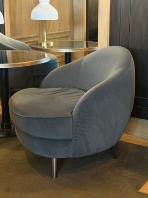 a chair and a table in a room with wood paneled walls