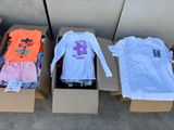 three boxes of clothing are lined up on a sidewalk