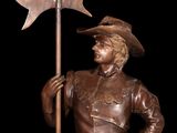 bronze statue of a man with a spear and a hat