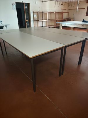 two ping pong tables in the middle of a room