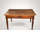 an old wooden table with two drawers on top of it