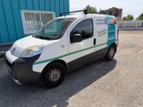 a white van parked in front of a blue building