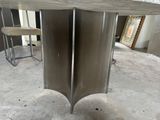 a table that has two legs on it in the middle of a room