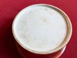a small bowl sitting on top of a red table