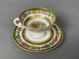 a small cup and saucer sitting on a table