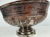 an ornate silver bowl on a pedestal with a white background