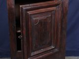 an old wooden cabinet with a door open on a tile floor